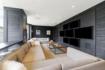 A modern living room with a large couch and a coffee table.